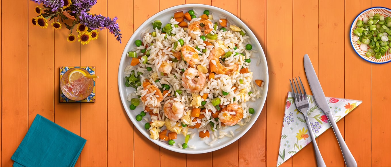 A bowl of shrimp fried rice, made from a recipe that takes less than 30 minutes to make.