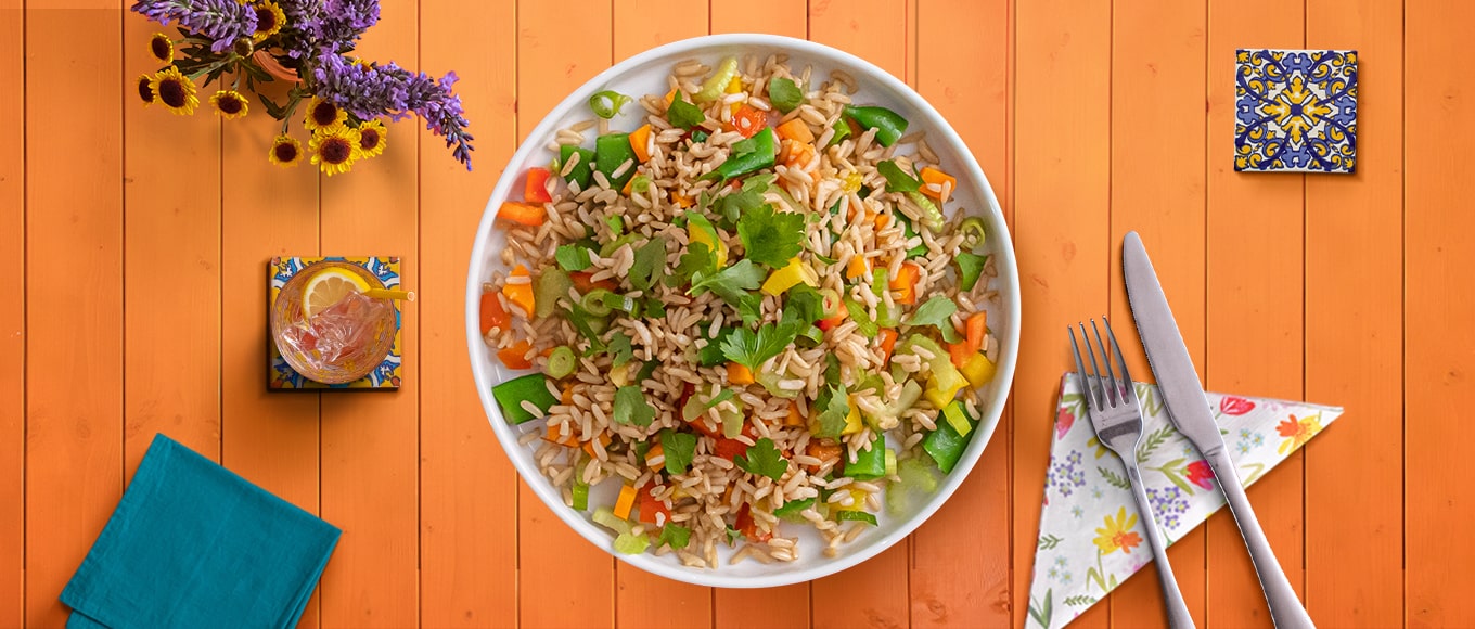 A rice salad recipe with colorful veggies, a tangy vinaigrette, and delicious rice.